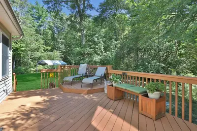 a deck with two chairs and a bench on it at Moondance Ridge Suites in New Paltz