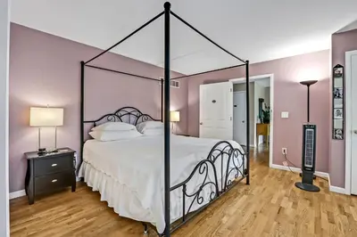 a bedroom with a large bed with a black frame at Moondance Ridge Suites in New Paltz