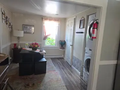 a hallway of a home with a washing machine at Comfortable home away from home in East Hartford
