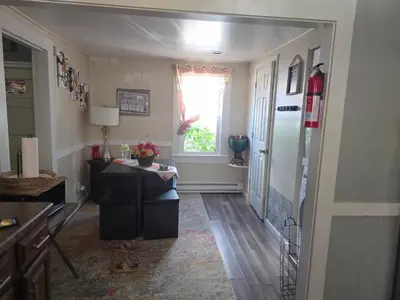 a hallway with a table and a window in a room at Comfortable home away from home in East Hartford