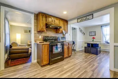 a kitchen with wooden cabinets and a stove at Comfortable home away from home in East Hartford