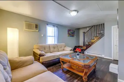 a living room with a couch and a coffee table at Comfortable home away from home in East Hartford