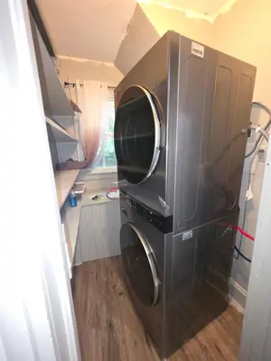 a microwave sitting in the corner of a room at downtown and secluded in Manchester