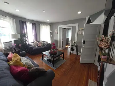 a living room with a couch and a table at downtown and secluded in Manchester