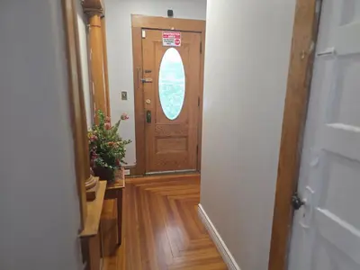 a hallway with a wooden door with a window at downtown and secluded in Manchester