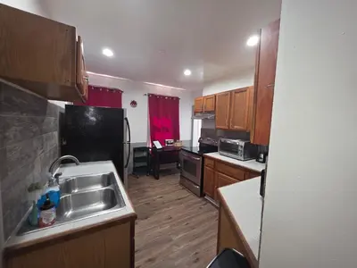 a kitchen with a sink and a refrigerator at downtown and secluded in Manchester