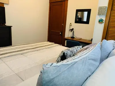a bedroom with a bed and a desk at Cozy First Floor Apartment in Chicopee