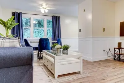 a living room with a couch and a table at Premier League Pad in Manchester