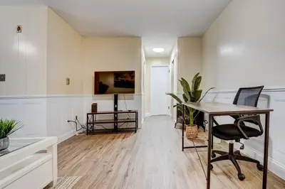 a living room with a desk and a table at Premier League Pad in Manchester