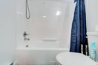 a bathroom with a toilet and a bath tub at Premier League Pad in Manchester
