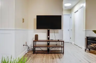 a living room with a flat screen tv on a wall at Premier League Pad in Manchester