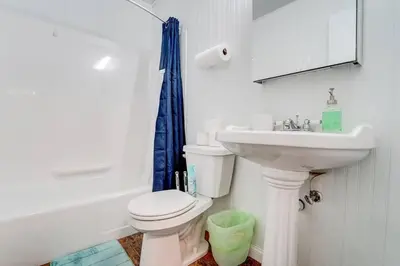 a bathroom with a white toilet and a sink at Premier League Pad in Manchester