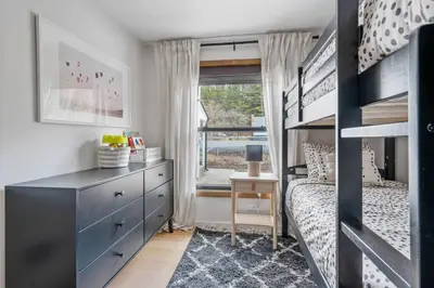 a bedroom with a bunk bed and a dresser at Chateau Bungalow - Ski Belleayre, Hunter in Shandaken