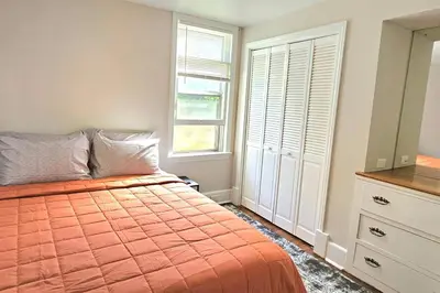 a bedroom with a bed and a dresser and a window at Modern 4BDRM West Hartford Home In Great Location! in West Hartford