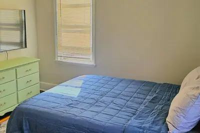 a bedroom with a blue bed and a dresser at Modern 4BDRM West Hartford Home In Great Location! in West Hartford