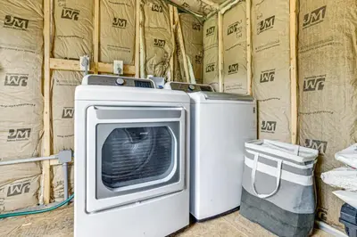a washer and dryer in a room with boxes at Catskills Tiny Home Cabin Surrounded by Nature! in Franklin