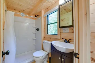 a bathroom with a white toilet and a sink at Catskills Tiny Home Cabin Surrounded by Nature! in Franklin