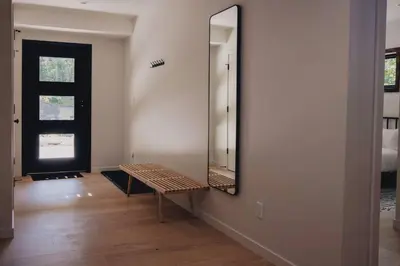 a room with a mirror and a bench in it at Emberwood Lodge - Luxury Cabin, Kid Friendly in Catskill