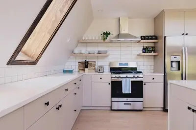 a kitchen with white cabinets and a stove at Emberwood Lodge - Luxury Cabin, Kid Friendly in Catskill