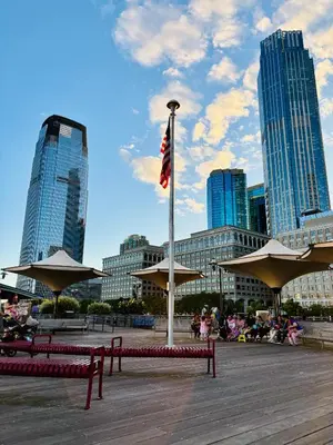 a flag on a pole in a city with buildings at Iron Bound Gem in Newark