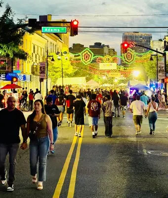 a crowd of people walking down a busy city street at Van Buren Gem 2.0 in Newark
