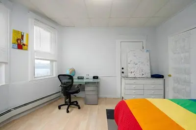 a bedroom with a bed and a desk and a chair at Skyline 3BR 20 MIN to T Square #2 in West New York
