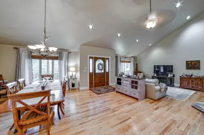 a dining room and living room with a dining table at 2 Mi to Elk Mountain Secluded Union Dale Home! in Pleasant Mount