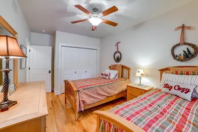 a bedroom with two beds and a ceiling fan at 2 Mi to Elk Mountain Secluded Union Dale Home! in Pleasant Mount