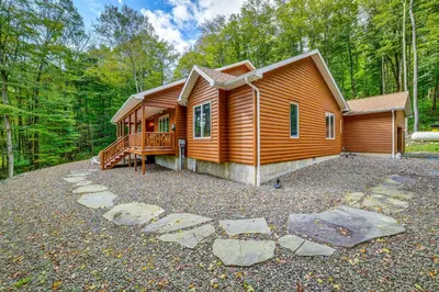 a log cabin in the woods with a large yard at 2 Mi to Elk Mountain Secluded Union Dale Home! in Pleasant Mount