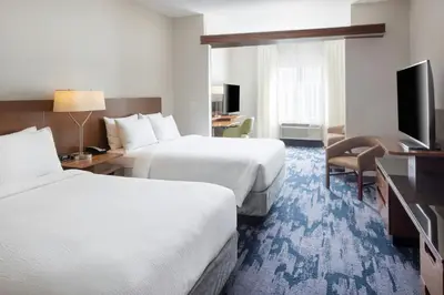 a hotel room with two beds and a television at Fairfield Inn & Suites by Marriott Springfield Northampton/Amherst in Northampton