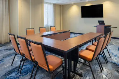 a conference room with a large wooden table and chairs at Fairfield Inn & Suites by Marriott Springfield Northampton/Amherst in Northampton