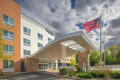an american flag flying in front of a hotel at Fairfield Inn & Suites by Marriott Springfield Northampton/Amherst in Northampton