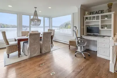 a dining room with a table and a desk at Candlewood Lake House in Danbury