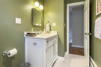 a bathroom with a sink and a mirror at Candlewood Lake House in Danbury