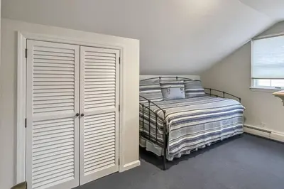 a bedroom with a bed and a window at Candlewood Lake House in Danbury