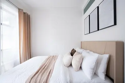 a bedroom with a bed with white sheets and pillows at 1290-13 Newly Renovated 2 Bedrooms in UES in New York
