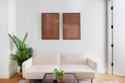 a living room with a white couch and a table at 1290-13 Newly Renovated 2 Bedrooms in UES in New York