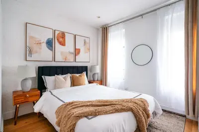 a bedroom with a bed with a blanket on it at 1290-6 Newly Renovated 2 Bedrooms in UES in New York