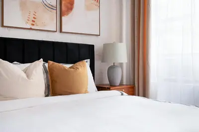 a bedroom with a bed with white sheets and pillows at 1290-6 Newly Renovated 2 Bedrooms in UES in New York