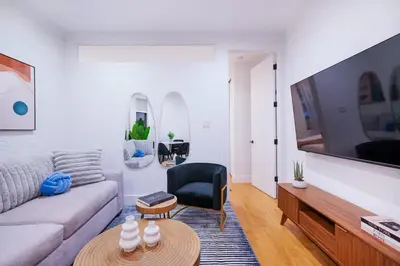 a living room with a couch and a table at 1290-6 Newly Renovated 2 Bedrooms in UES in New York