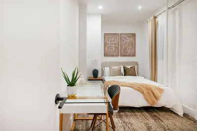 a bedroom with a bed and a table and a desk at 1290-8 New Renovated 2 Bedrooms in UES in New York