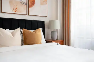 a bedroom with a bed with white sheets and pillows at 1290-8 New Renovated 2 Bedrooms in UES in New York