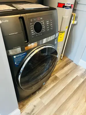 a black washing machine sitting in a room at Spacious Apartment Downtown Albany, NY in Albany