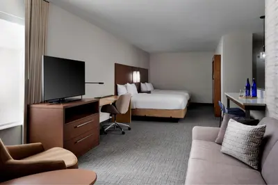 a hotel room with a bed and a television at Inn at Bellefield Residence Inn by Marriott in Hyde Park