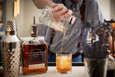 a man pouring a drink into a glass at Inn at Bellefield Residence Inn by Marriott in Hyde Park