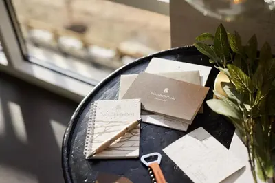 a black table with cards and a vase on it at Inn at Bellefield Residence Inn by Marriott in Hyde Park