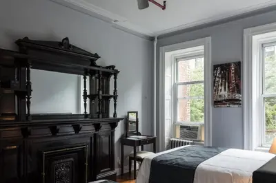 a bedroom with a large bed and a mirror at The Central Park North in New York