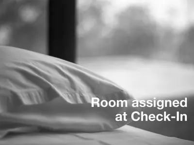 a pillow sitting on a bed with the words room assigned at check in at The Central Park North in New York