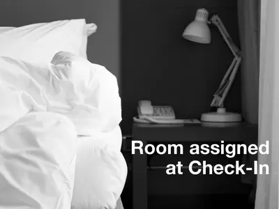 a person sleeping in bed with a room assigned at check in at The Central Park North in New York