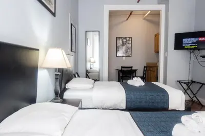 a hotel room with two beds and a television at The Central Park North in New York